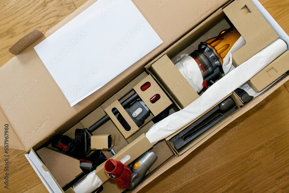 Paris, France - Jul 4, 2022: Cardboard package box with modern wireless Dyson  V12 Detect Slim Absolute Vacuum Cleaner powerful cordless colorful cyclonic  dust collection - above view Photos | Adobe Stock