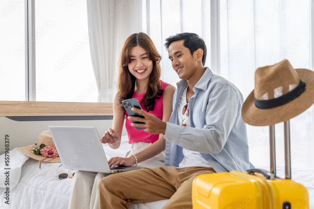 Asian couples are preparing to travel together both domestically and internationally. Have a good travel plan through the Internet. Both of them are happy and excited about going on a trip together. Asian couples are preparing to travel together both domestically and internationally. Have a good travel plan through the Internet. Both of them are happy and excited about going on a trip together.