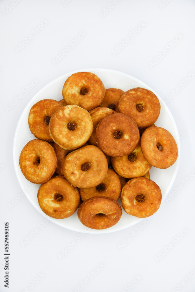 Round shortbread cookies on a plate. Soft sweet cake on a white background. A sweet snack. Round shortbread cookies on a plate. Soft sweet cake on a white background. A sweet snack.