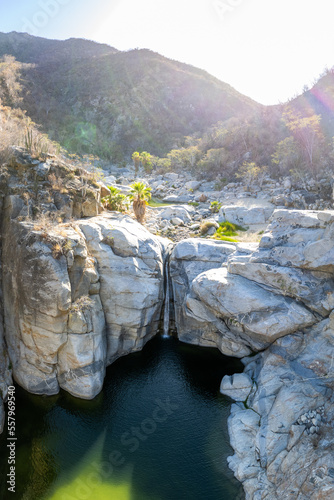 Aerial view of Zorro Canyon Waterfall in the ecological ranch Sol De Mayo on a sunny day in Santiago, Baja California Sur, Mexico