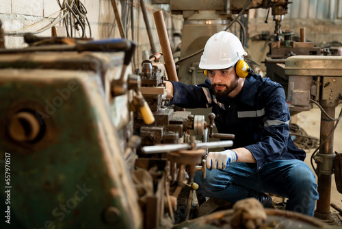 Team of engineers practicing maintenance Taking care and practicing maintenance of old machines in the factory so that they can be used continuously.