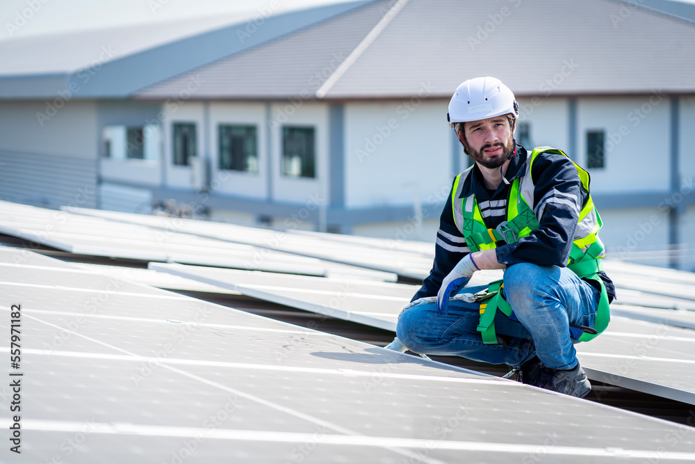 Male engineer installing or checking the working condition of solar panels on the roof or at the height of the factory for saving electricity was broken to use renewable energy from the sun Male engineer installing or checking the working condition of solar panels on the roof or at the height of the factory for saving electricity was broken to use renewable energy from the sun