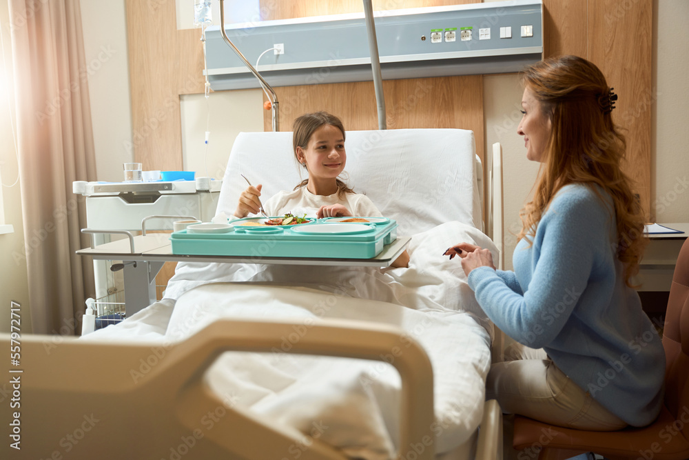 Recovering girl is having breakfast in a hospital room Recovering girl is having breakfast in a hospital room
