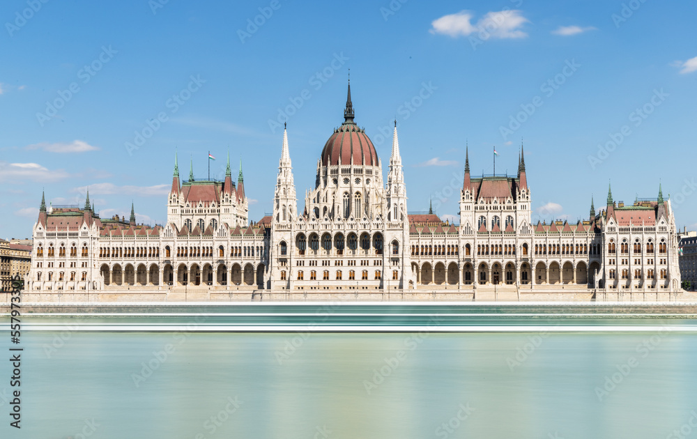 Hungarian parliament building on Danube, Budapest, long exposure square, clear blue sky, European architecture