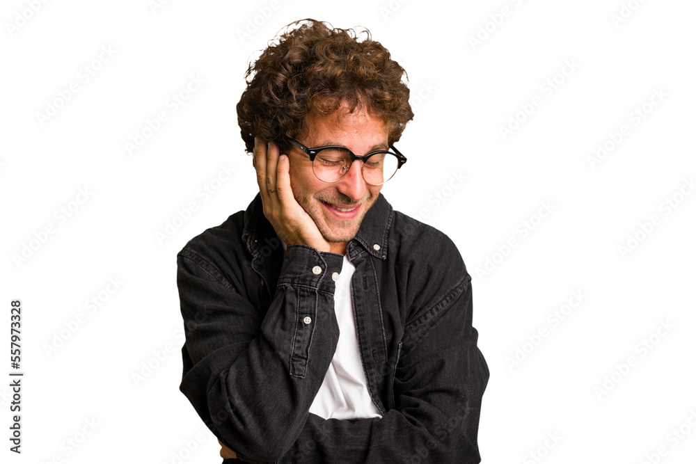 Obraz premium Young curly smart caucasian man cut out isolated laughs happily and has fun keeping hands on stomach.