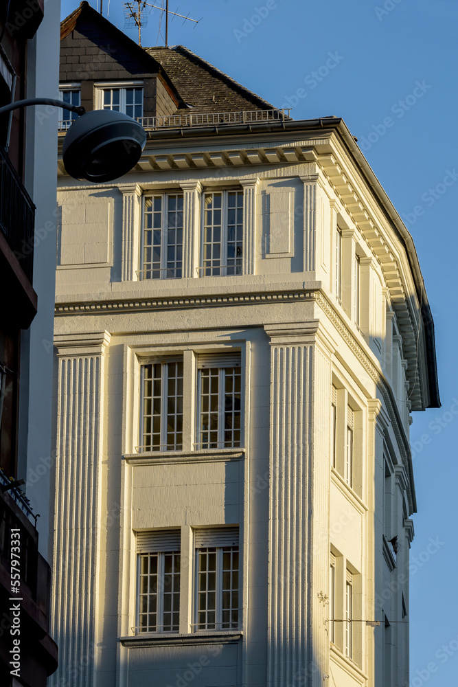 Prestigious apartment building with tall windows and clear blue sky in the background - luxury real estate