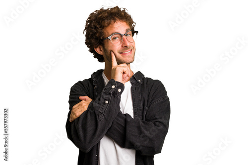 Young curly smart caucasian man cut out isolated smiling happy and confident, touching chin with hand.