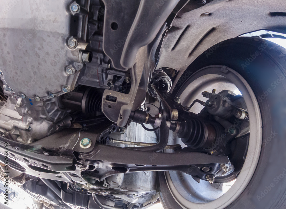 View of car suspension system and various chassis components. Mechanical Services. Brakes Inspection and tire inspection. Mechanical repair, safety inspection, used vehicle appraisal. View of car suspension system and various chassis components. Mechanical Services. Brakes Inspection and tire inspection. Mechanical repair, safety inspection, used vehicle appraisal.