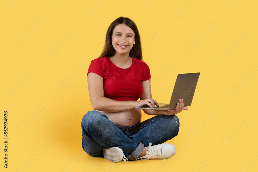 Remote Work During Pregnancy. Happy Pregant Female Sitting On Floor With Laptop Remote Work During Pregnancy. Happy Pregant Female Sitting On Floor With Laptop