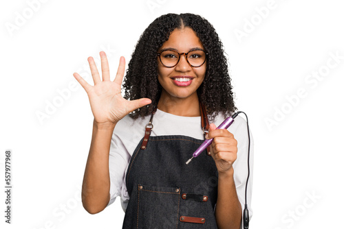 Tableau sur toile Young african american manicurist woman holding an electric file drill isolated smiling cheerful showing number five with fingers
