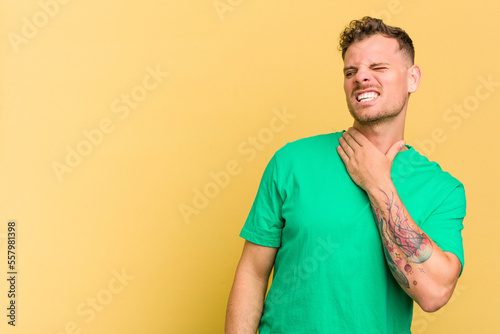 Young caucasian handsome man isolated on yellow background touching back of head, thinking and making a choice.