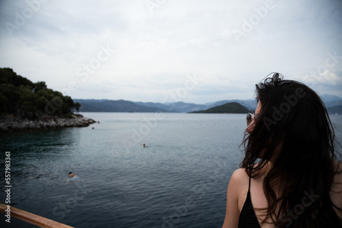 Portrait of beautiful woman relaxing and looking at view on ferry © mehmetugurozer