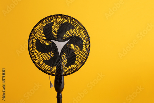 black fan on yellow background