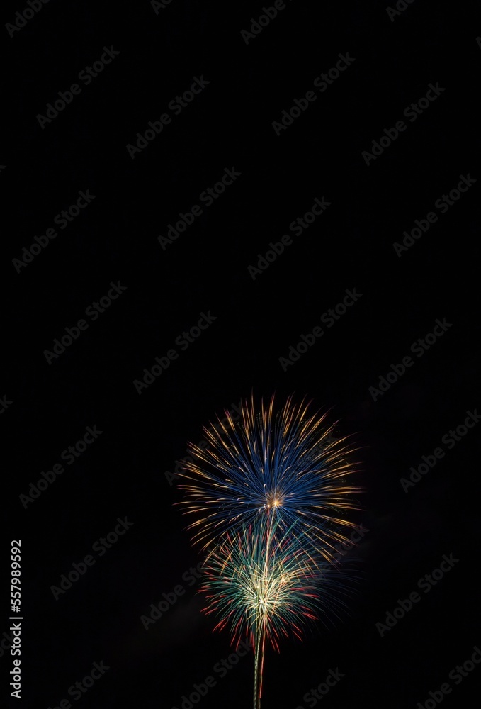 Vivid Fourth of July skyrockets, as seen from above, with lightning bolt to the left, Cottonwood, Arizona.