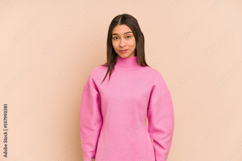 Young colombian woman isolated on beige background sad, serious face, feeling miserable and displeased. Young colombian woman isolated on beige background sad, serious face, feeling miserable and displeased.