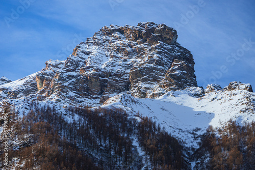 The mountains, glaciers and snow of Val Malenco, during a sunny winter day, near the village of Chiesa in Valmalenco, Italy - December 2022. photo