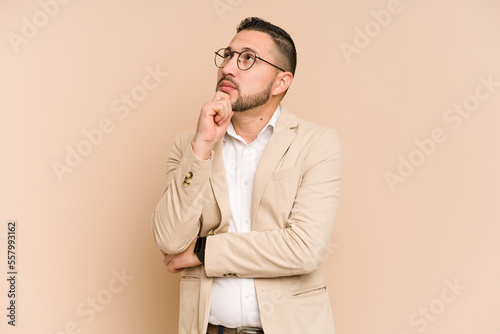 Adult latin business man cut out isolated looking sideways with doubtful and skeptical expression. © Asier