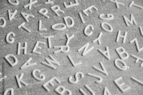 White letters English alphabet gray concrete background.
