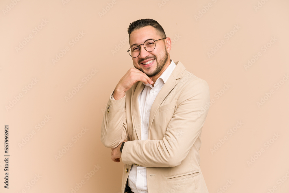 Adult latin business man cut out isolated smiling happy and confident, touching chin with hand.