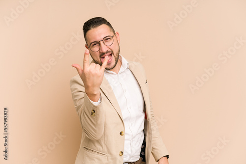 Adult latin business man cut out isolated showing rock gesture with fingers © Asier