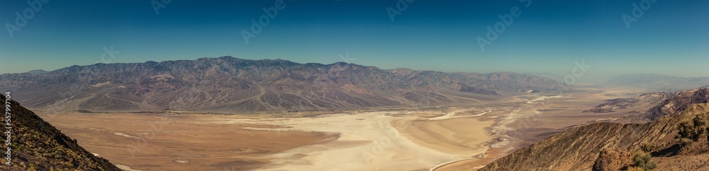 Naklejka premium Panorama view from hill to desert salt Death Valley in Viewpoint on hill to desert salt valley in america at blue sunny day