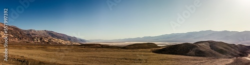 Sandy desert plain with rocky mountains witout life in Death Valley at sunny day, america © AllThings