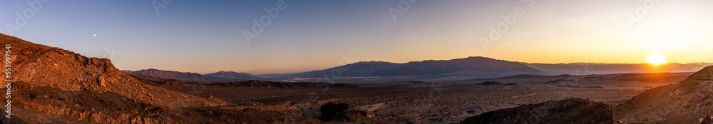 Panorama view of sandy and rocky desert nature in Death Valley at sunset in america