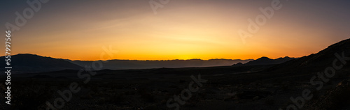 Panorama view of sandy and rocky desert nature in Death Valley at sunset in america