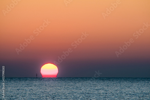 Fototapeta Naklejka Na Ścianę i Meble -  Beach seascape horizon. Orange and golden sunset sky calmness relaxing sunlight. Panoramic landscape and summer mood.
