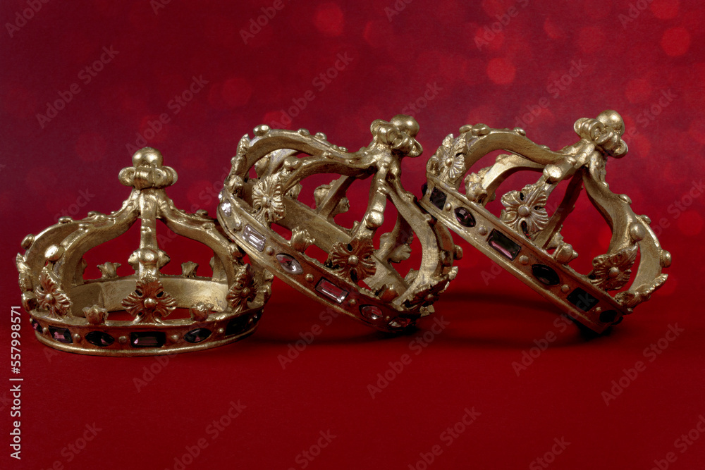 Happy Three King's Day. Three gold crowns on red background. Concept for Reyes Magos, Three Wise Men or Happy Epiphany day. Happy Three King's Day. Three gold crowns on red background. Concept for Reyes Magos, Three Wise Men or Happy Epiphany day.