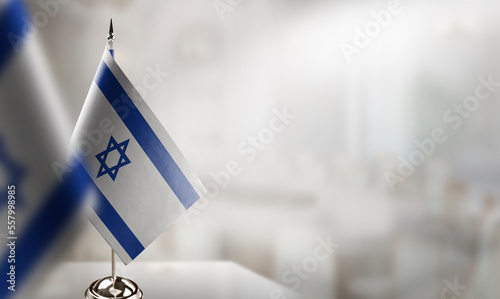 Small flags of the Israel on an abstract blurry background