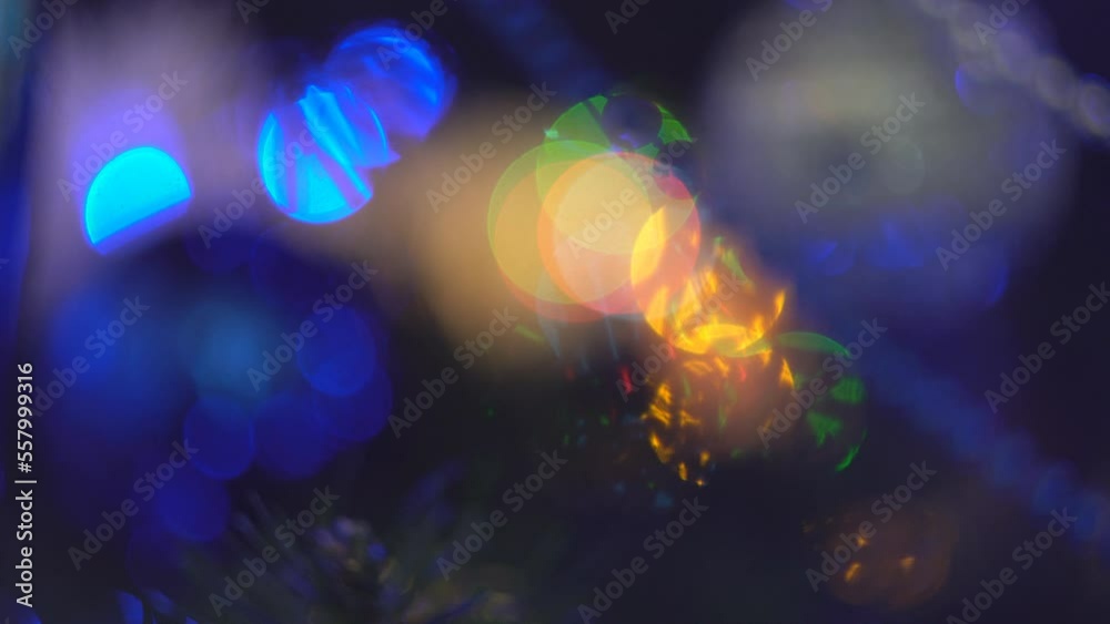 Christmas decorations for the Christmas tree and glowing lights of garlands. Christmas decorations with glossy jewelry decorate pine branches for the New Year holiday