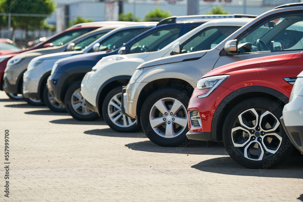row of used cars. Rental or automobile sale services - obrazy, fototapety, plakaty 