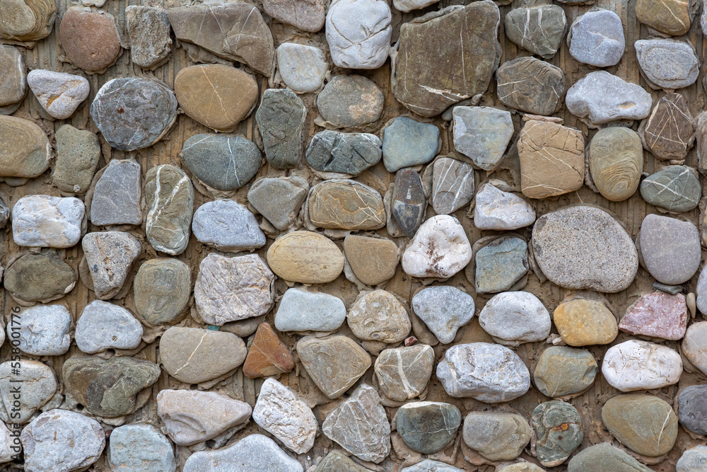Stone wall made of pebbles, background, texture, backdrop Stone wall made of pebbles, background, texture, backdrop