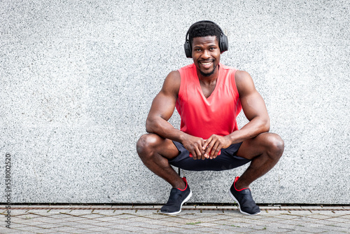 Slika na platnu african american sports guy in headphones listening to music outdoors against wa