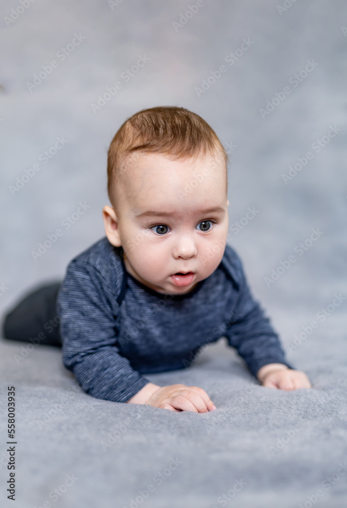Handsome toddler portrait. Curious baby boy studying nursery room Handsome toddler portrait. Curious baby boy studying nursery room