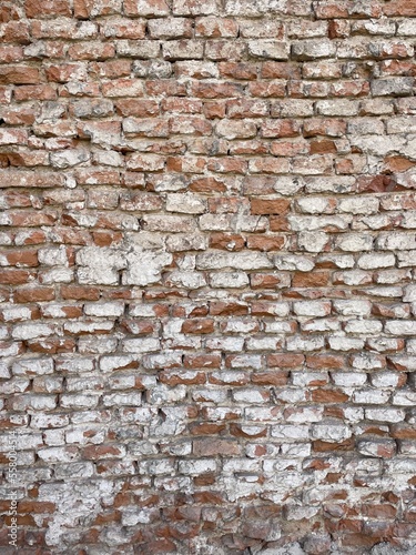 Vintage cracked bricks wall with cements texture. Bricks urban background