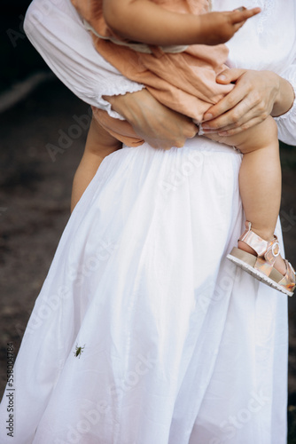 child in mother's arms without a face © Liudmyla