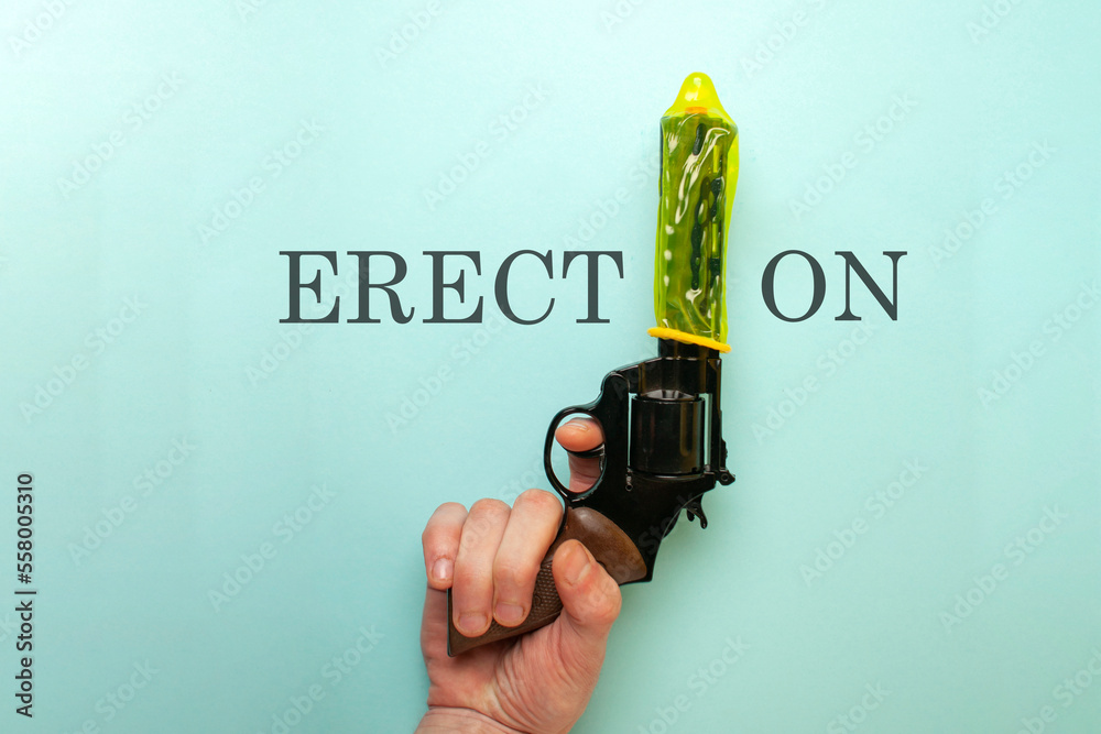 concept of a strong condom, a yellow contraceptive dressed on the muzzle of a gun, the concept