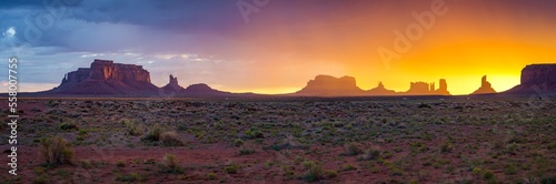 great panorama view of during rainy sunrise in monument valley photo