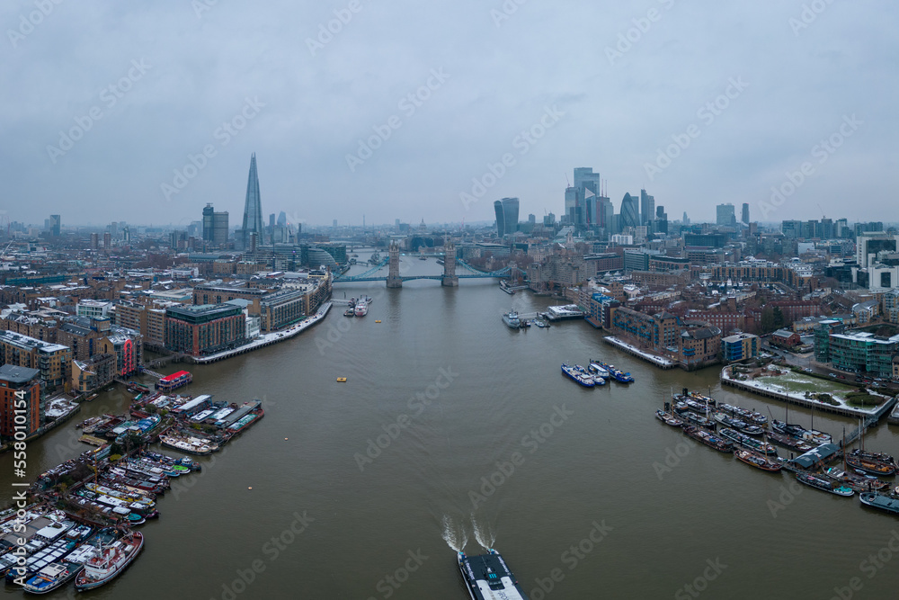 London and Tower Bridge over River Thames on a foggy day - LONDON, UNITED KINGDOM - DECEMBER 20, 2022