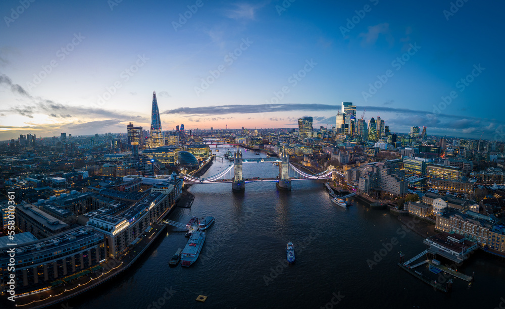 London with River Thames and Tower Bridge - amazing aerial view in the evening - LONDON, UNITED KINGDOM - DECEMBER 20, 2022