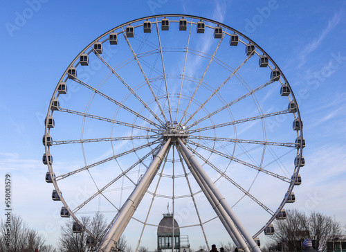Montreal tourism - ferris wheel, details, on blue sky background. Amusement park, festive mood. viewpoint