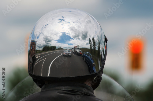 chrome motorcycle helmet with reflections of cars