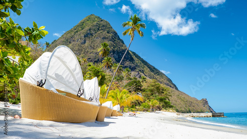 Fototapeta Naklejka Na Ścianę i Meble -  Sugar beach Saint Lucia, a public white tropical beach with palm trees and luxury beach chairs on the beach of the Island St Lucia Caribbean 