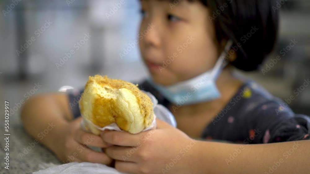 Select focus chicken floss bun hold by little girl Select focus chicken floss bun hold by little girl
