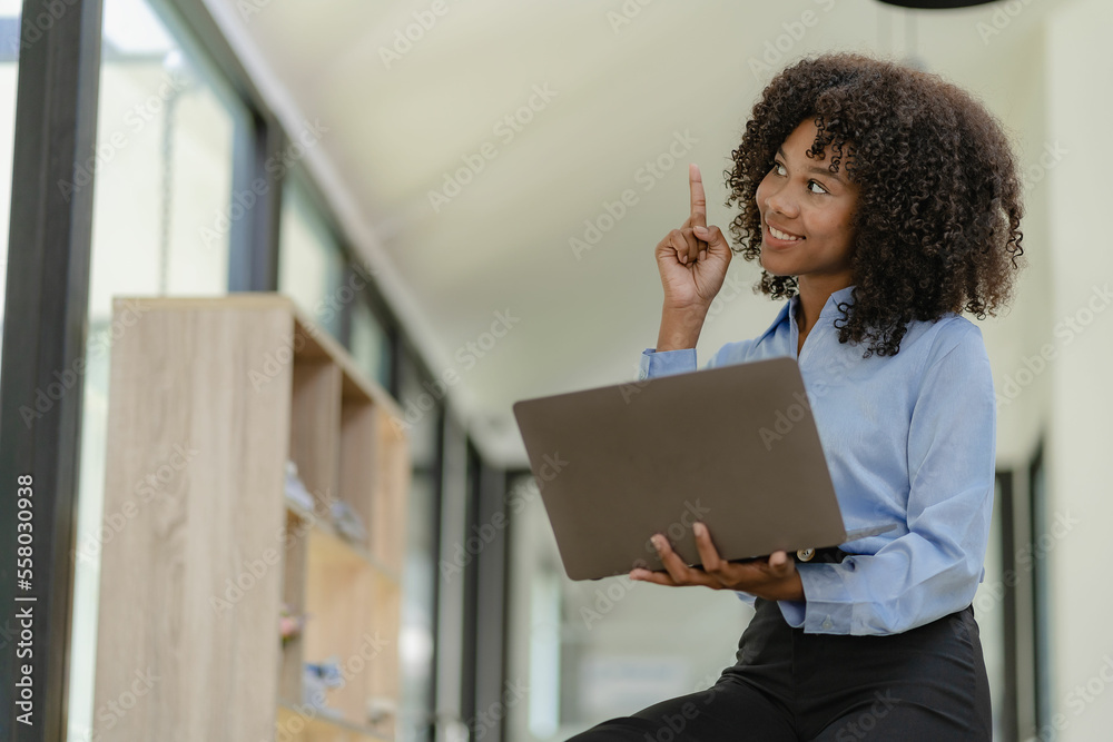 Young happy successful business woman working with laptop and calculating analytical calculator with financial graph document in office online meeting concept Young happy successful business woman working with laptop and calculating analytical calculator with financial graph document in office online meeting concept