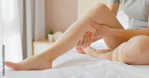 woman touch leg photo