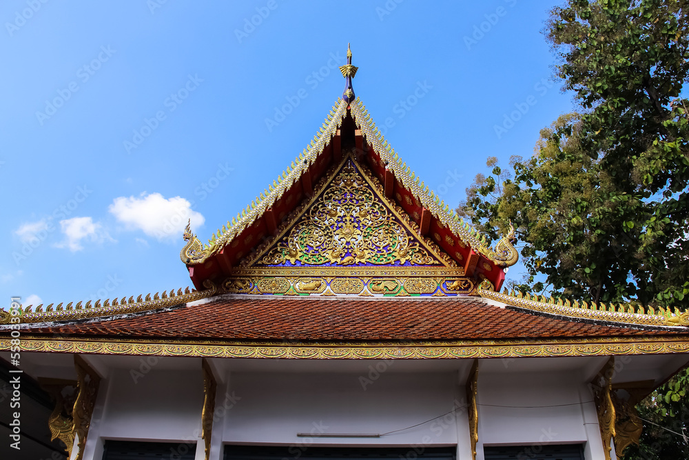 Beauty roof in  Thailand  temple on bright blue sky background