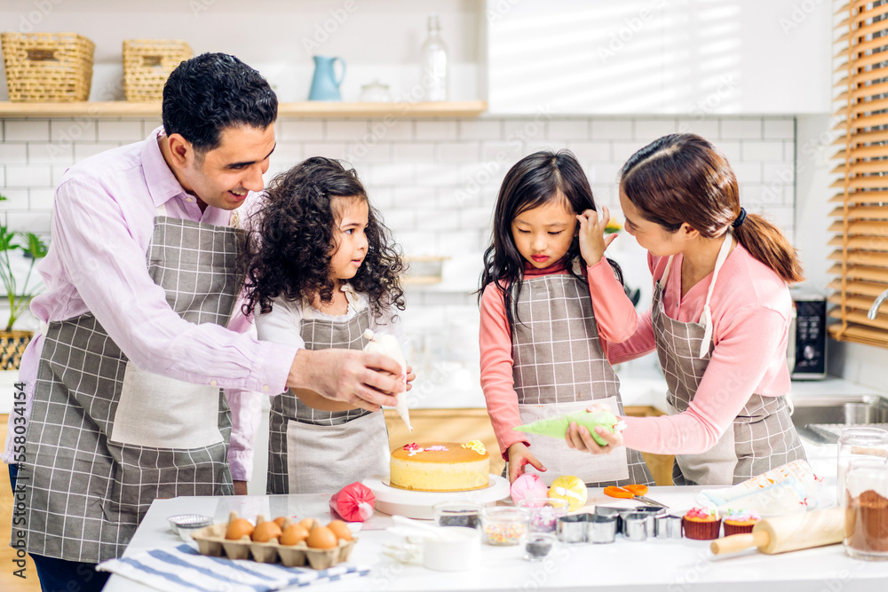 Portrait of enjoy happy love asian family father and mother with little asian girl daughter child play and having fun cooking food together with baking cookie and cake ingredient in kitchen Portrait of enjoy happy love asian family father and mother with little asian girl daughter child play and having fun cooking food together with baking cookie and cake ingredient in kitchen